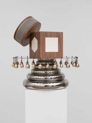 An object made of round and angular elements of wood and metal with bells.