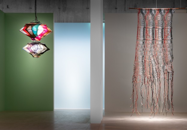 An installation view with lamps and macramé